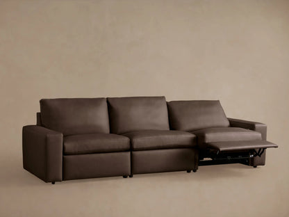 Kipton wide-arm 3-piece dark brown leather motion sofa with two footrests extended, shown against a neutral wall.