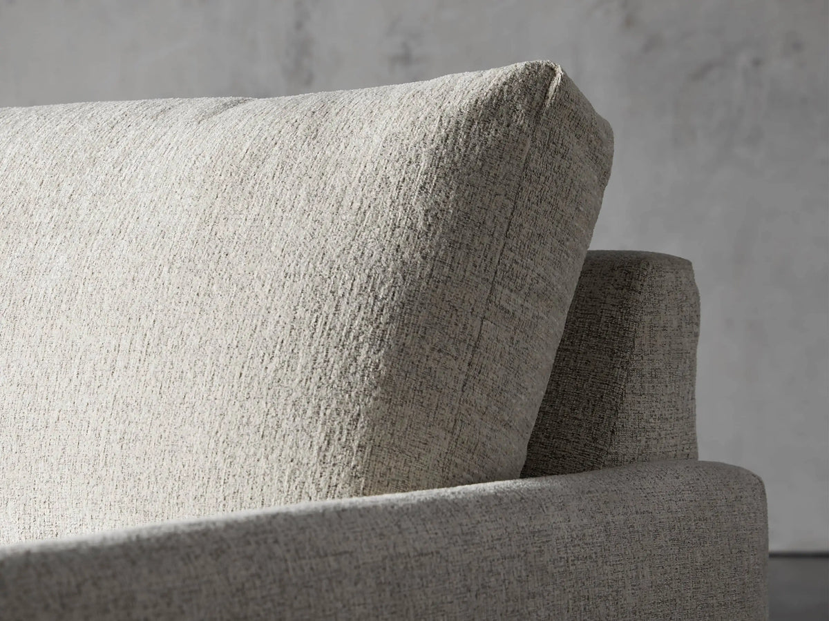 Front view of the cream Kipton Slim Two Arm Chaise, showcasing its slim design and textured upholstery.