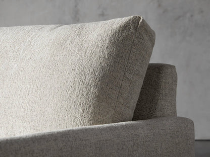 Front view of the cream Kipton Slim Two Arm Chaise, showcasing its slim design and textured upholstery.