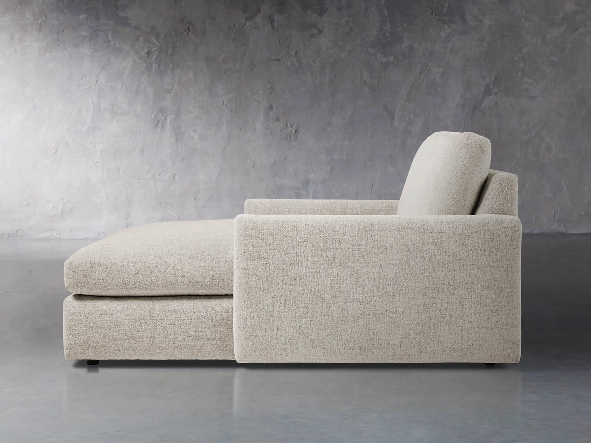 Close-up of the textured light grey fabric on the back cushion and armrest of the Kipton Slim Two Arm Chaise.