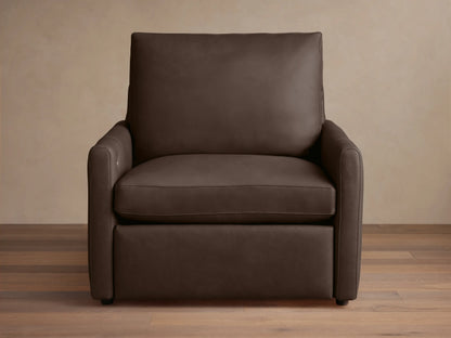 A dark brown Kipton Leather Motion Recliner with a sleek design. Features smooth leather, slim arms, and cushioned backrest on a wooden floor.