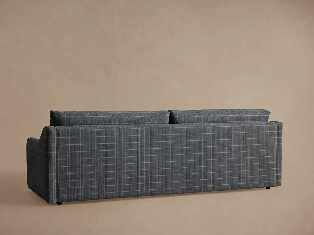 Close-up of Kipton Slope Arm Sofa, grey fabric with white plaid pattern, showing the sloped arm and backrest.