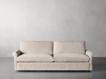 Front view of the beige textured Kipton Rolled Arm Sofa, featuring two seat cushions, two back cushions, and rolled arms.