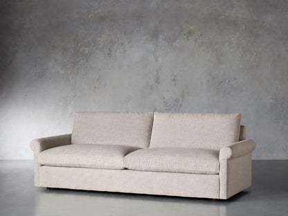 Front view of the beige textured Kipton Rolled Arm Sofa, featuring two seat cushions, two back cushions, and rolled arms.