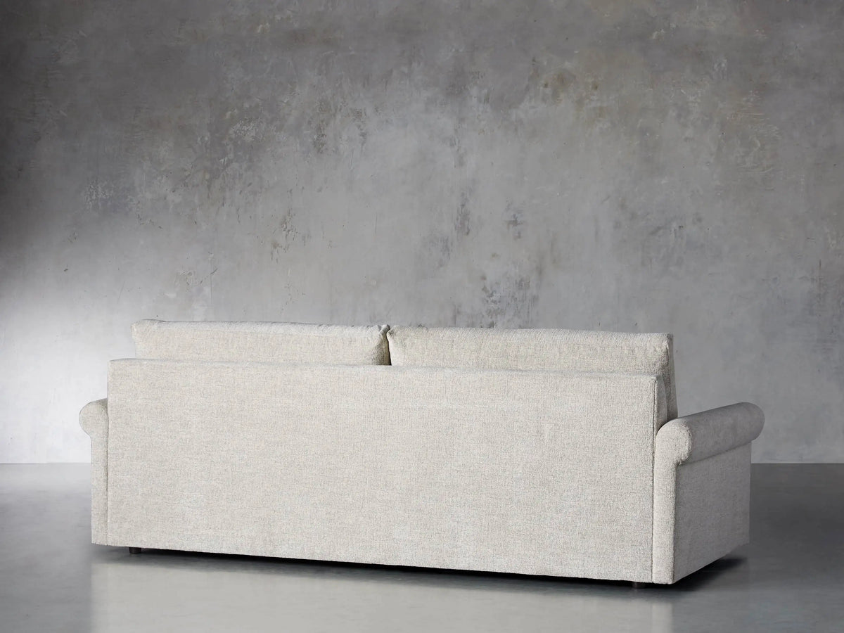 Close-up of the light beige textured woven fabric on the rolled arm of the Kipton Rolled Arm Sofa.