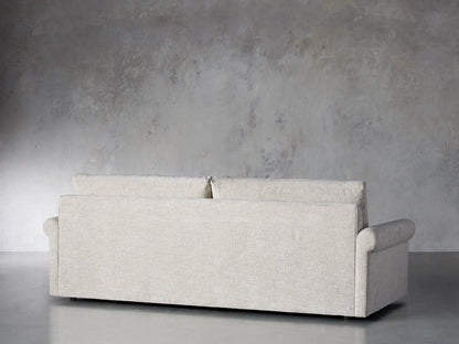 Close-up of the light beige textured woven fabric on the rolled arm of the Kipton Rolled Arm Sofa.