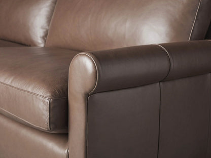 Front view of the brown Kipton Leather Rolled Arm Sofa with two seat cushions and rolled arms.