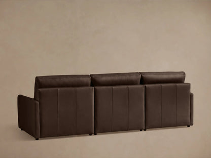 Close-up of the Kipton Leather Three-Piece Motion Modular Sofa armrest in dark brown leather with visible two-button control.