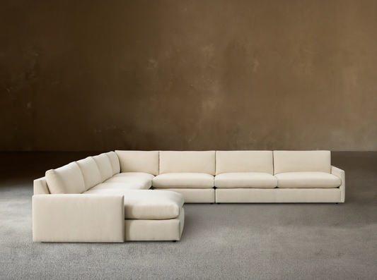Kipton Slim Arm Five-Piece Chaise Sectional, cream fabric, L-shaped with a left-facing chaise on a wooden floor.