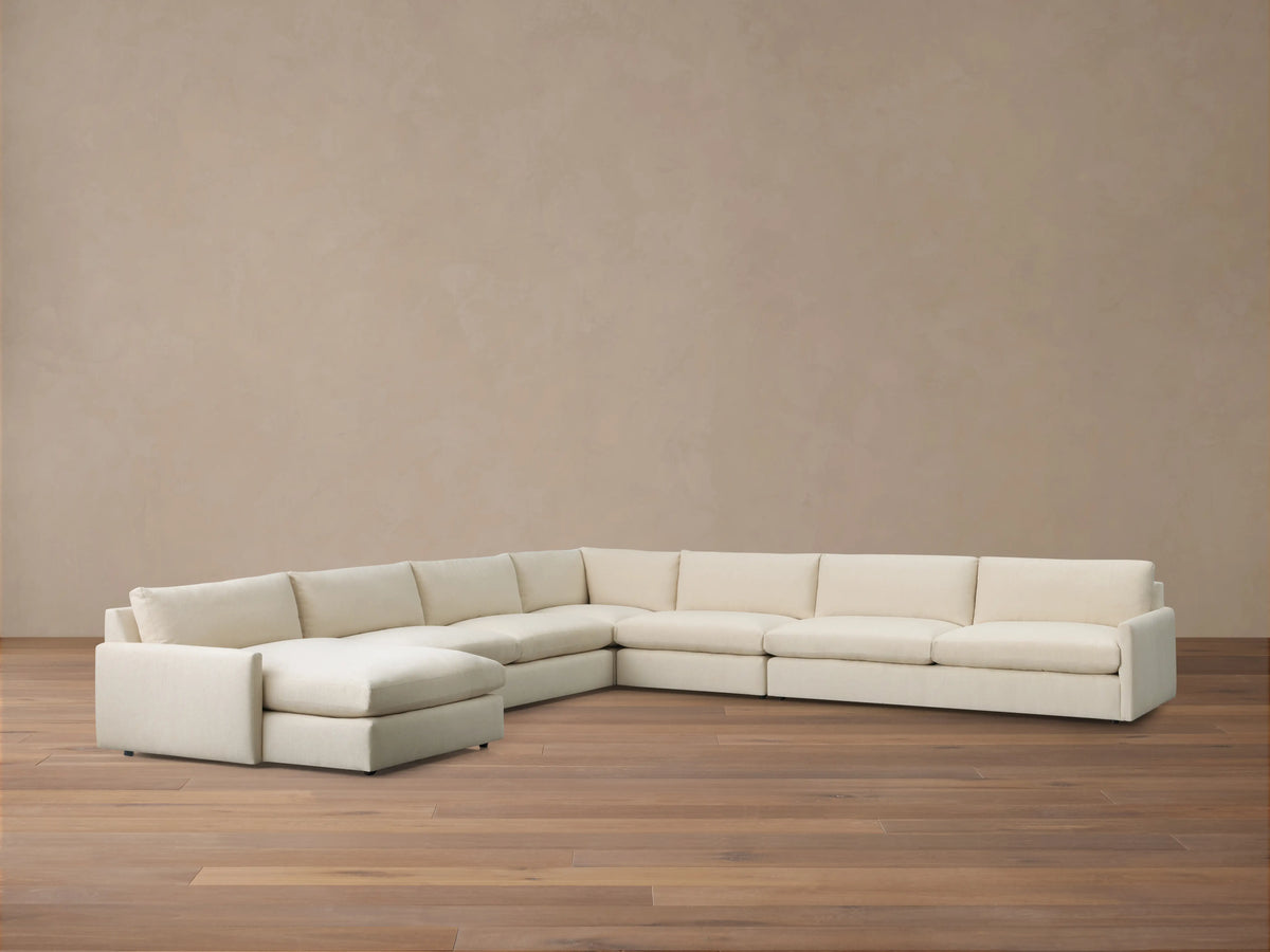Kipton Slim Arm Five-Piece Chaise Sectional, cream fabric, L-shaped with a left-facing chaise on a wooden floor.