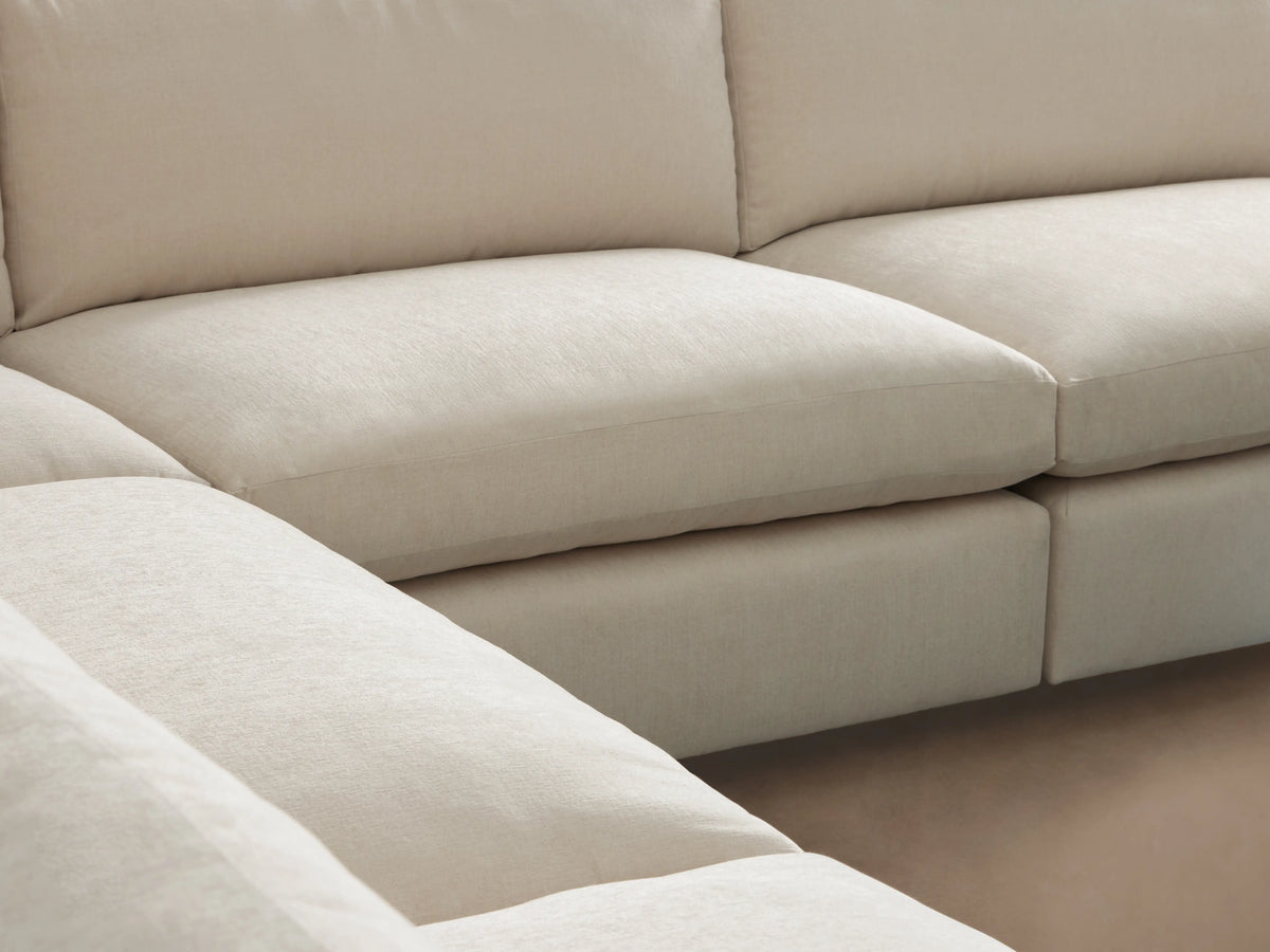 Kipton Slim Arm Five-Piece Chaise Sectional in cream fabric, L-shaped, on a wooden floor against a light wall.