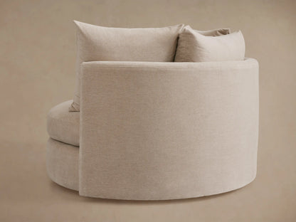 Kipton Oversized Swivel Chair in beige fabric, showing a close-up of the cushioned seat and matching large back pillow.