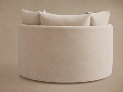 Kipton Oversized Swivel Chair in beige fabric, featuring a rounded back and plush cushions, against a neutral background.