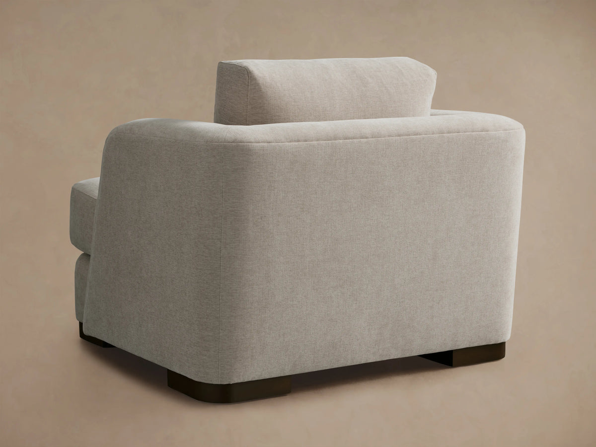 Kayden Chair in beige Crypton® fabric, featuring a plush backrest and seat cushion, with rounded armrests on a neutral backdrop.
