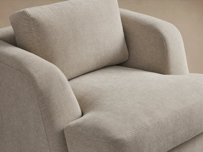 Beige Kayden Swivel Chair with soft upholstery, round arms, cushioned seat and back, set on a hardwood floor.