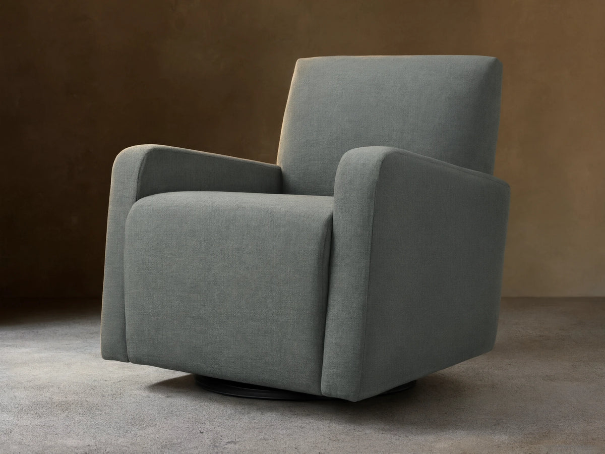 Gray upholstered Kershaw Swivel Chair with soft, textured fabric. Features wide armrests, a high backrest, and a concealed swivel base.