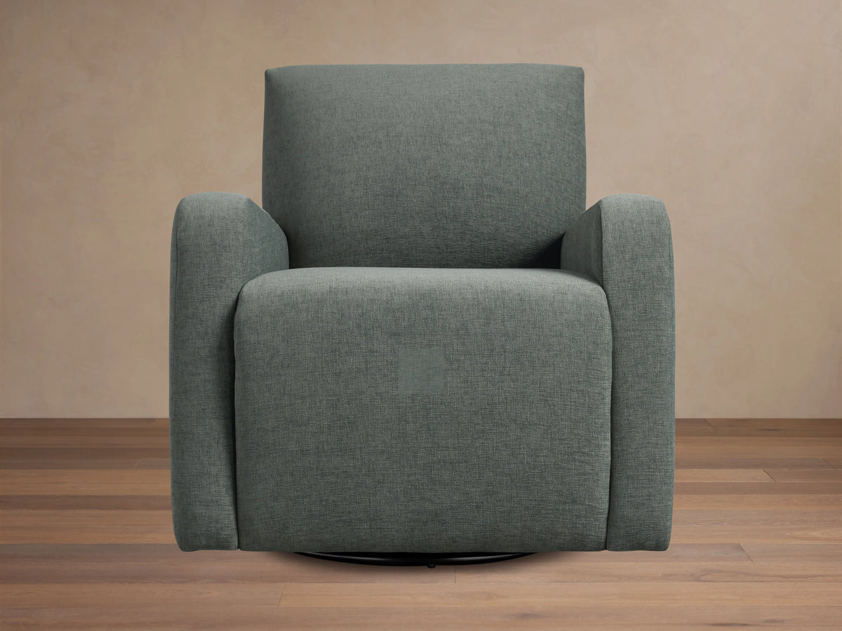 Gray upholstered Kershaw Swivel Chair with soft, textured fabric. Features wide armrests, a high backrest, and a concealed swivel base.