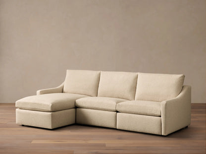 Front view of a light beige Kipton Slope Arm Three-Piece Motion Chaise Sectional with a left-facing chaise.