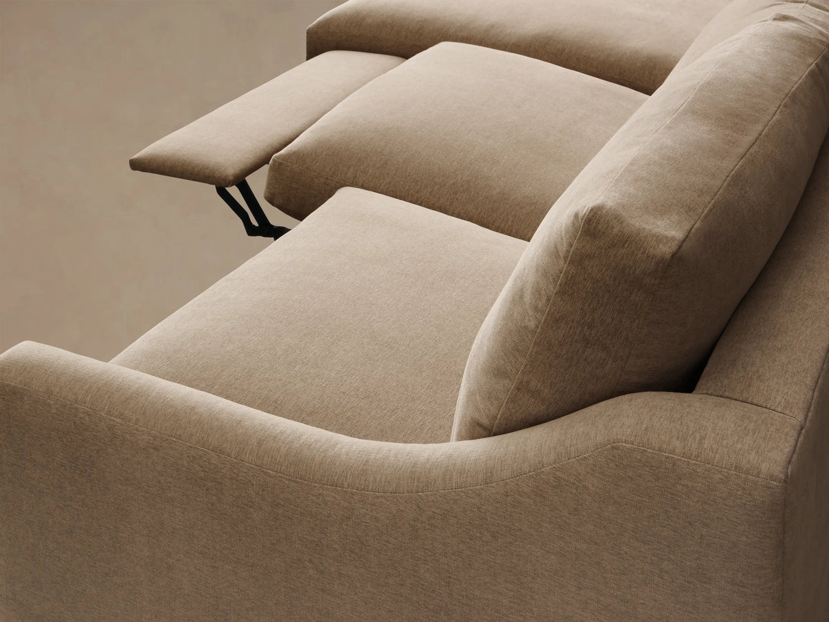 Close-up of the beige Kipton Slope Arm Three-Piece Motion Chaise Sectional's textured fabric and silver control button.