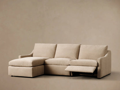 Front view of the light beige Kipton Slope Arm Three-Piece Motion Chaise Sectional with the middle footrest elevated.
