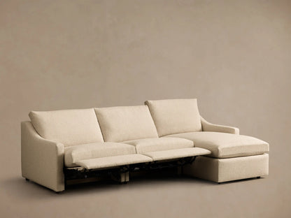 Front view of Cream Kipton Slope Arm Three-Piece Motion Chaise Sectional with two footrests extended and right-facing chaise.