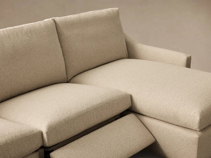 Close-up of the beige Kipton Slope Arm Three-Piece Motion Chaise Sectional with an extended footrest.