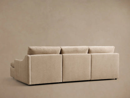 Rear view of the beige Kipton Slope Arm Three-Piece Motion Chaise Sectional, showing three back cushions.