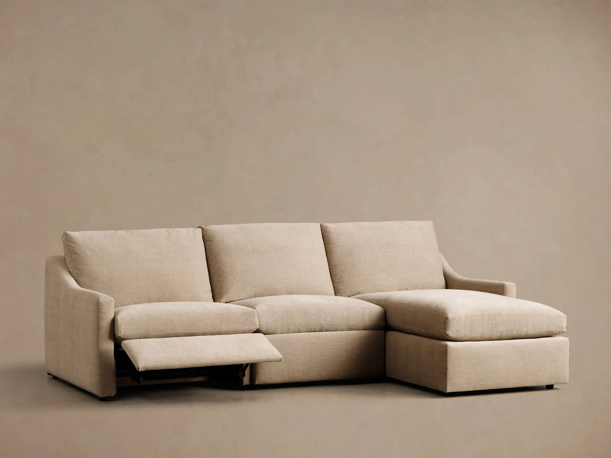 Front view of the beige Kipton Slope Arm Three-Piece Motion Chaise Sectional, featuring an L-shape design.