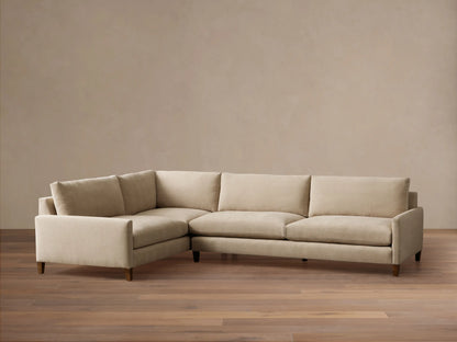 Front view of a light beige Kipton‚Ñ¢ Slim Arm Elevated Two-Piece Sectional with slim arms, elevated on dark mocha finish legs.