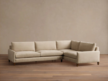 Front view of a light beige Kipton Slim Arm Elevated Two-Piece Sectional with slim arms and mocha finish wooden feet.