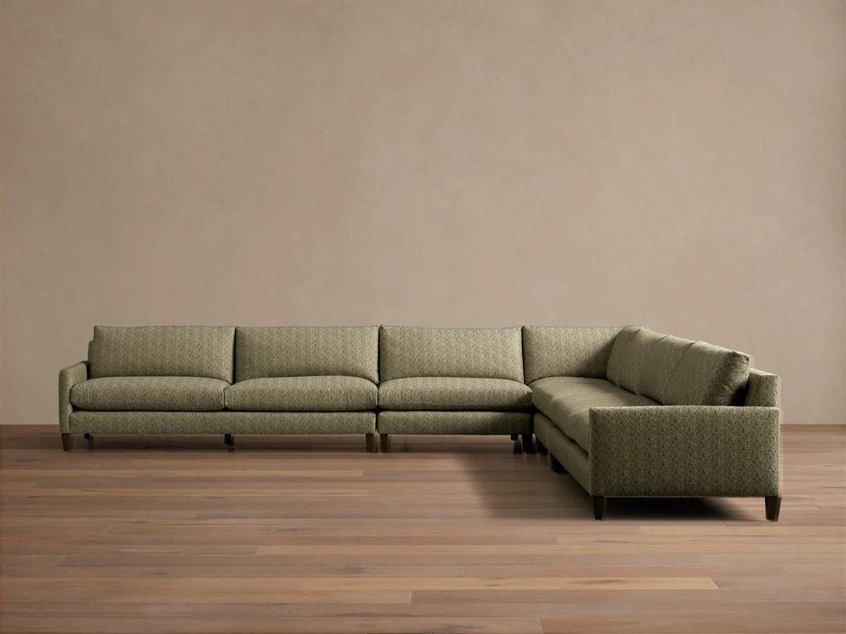 Front-angle view of the green Kipton Slim Arm Elevated Five-Piece Corner Sectional with slim arms and elevated mocha feet.