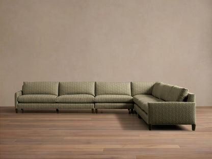 Front-angle view of the green Kipton Slim Arm Elevated Five-Piece Corner Sectional with slim arms and elevated mocha feet.