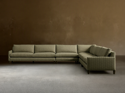 Front-angle view of the green Kipton Slim Arm Elevated Five-Piece Corner Sectional with slim arms and elevated mocha feet.