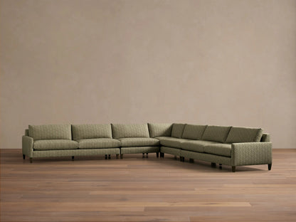 Front view of the green patterned Kipton Slim Arm Elevated Five-Piece Corner Sectional with slim arms and mocha finished elevated feet.