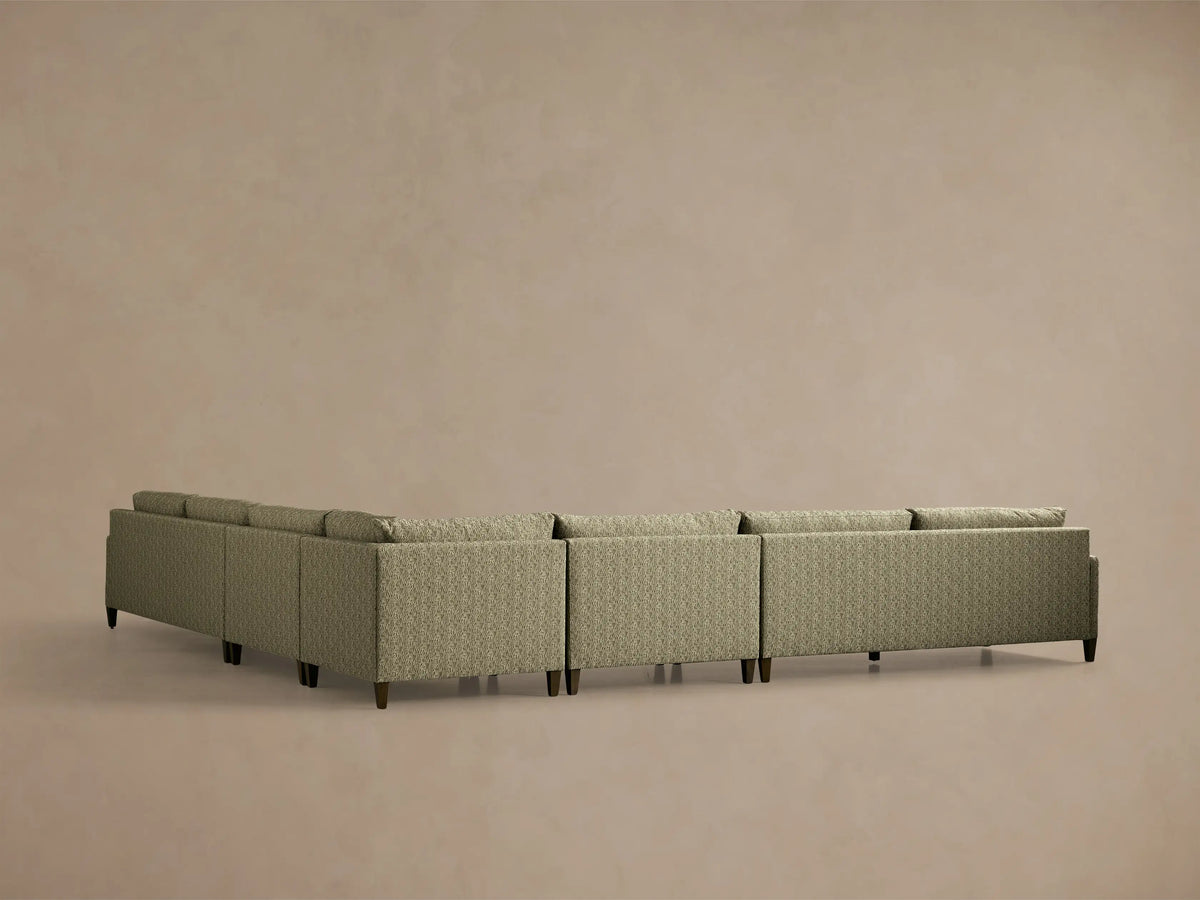 Front-angle view of the green Kipton Slim Arm Elevated Five-Piece Corner Sectional with slim arms and elevated mocha feet.