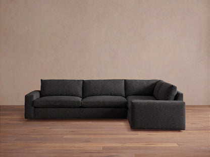 Front view of the dark gray Kipton Wide Arm Two-Piece Sectional, an L-shaped sofa with wide arms and a right-hand chaise.
