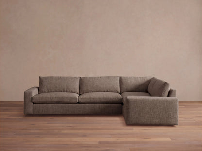 Front view of the brown Kipton Wide Arm Two-Piece Sectional, featuring wide arms and a textured woven fabric.