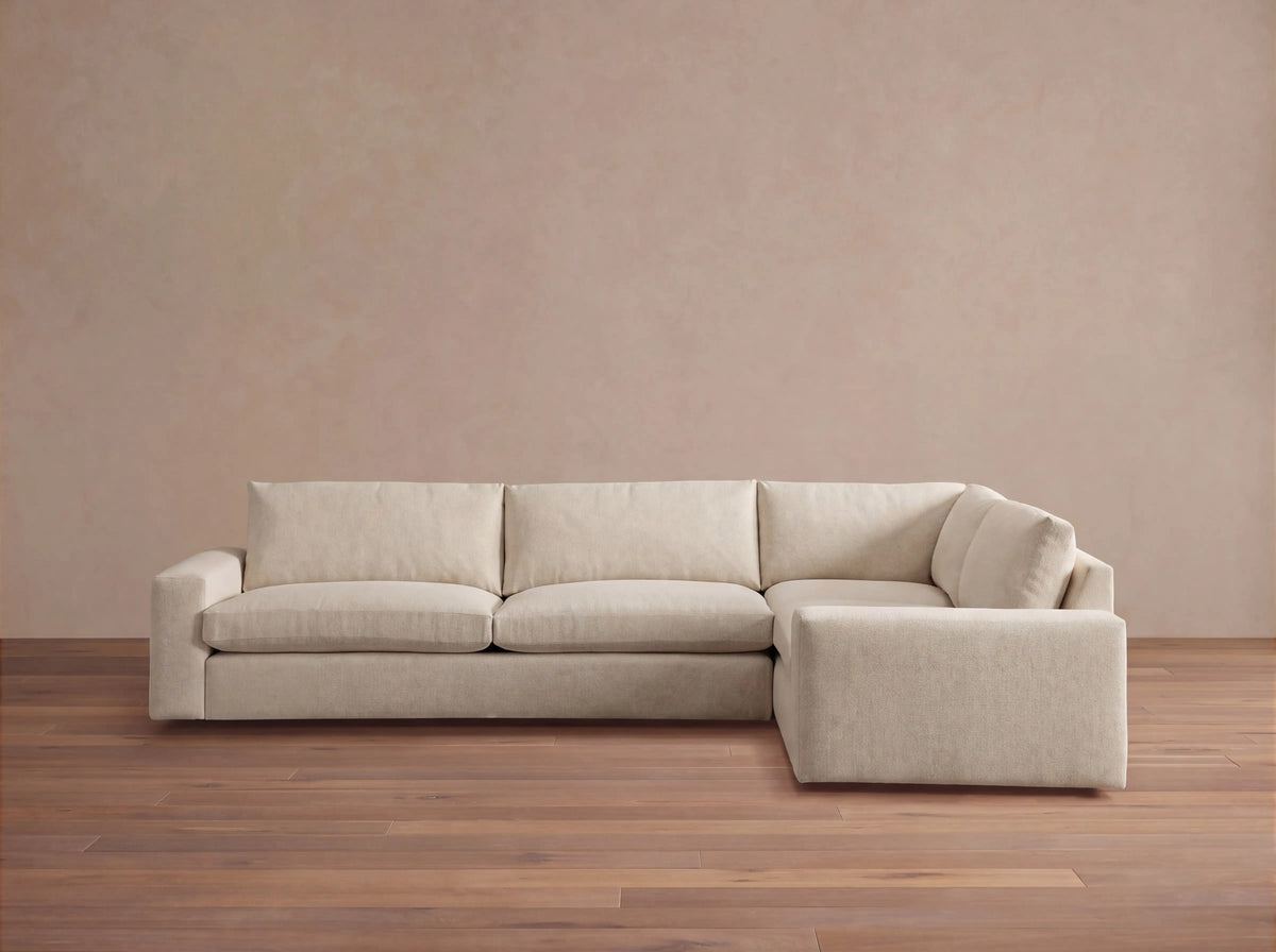 Front view of a light beige Kipton Wide Arm Two-Piece Sectional, L-shaped with wide arms and textured fabric upholstery.
