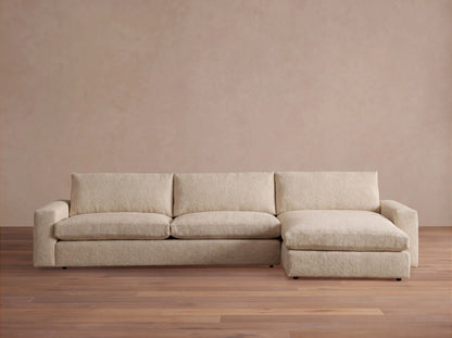 Light beige Kipton Wide Arm Two-Piece Chaise Sectional with a right-hand chaise and wide track arms, on white background.