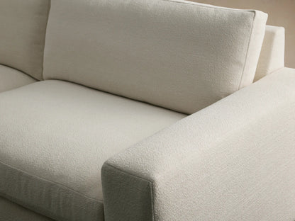 Kipton Wide Arm Sofa, off-white textured fabric, 2 seat/back cushions, wide square arms, on a wooden floor.
