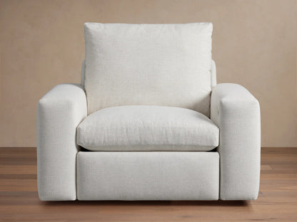 Kipton Wide Arm Motion Recliner, light beige upholstered fabric, front view. Wide arms & plush cushions. Power controls on arm.