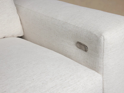 Kipton Wide Arm Motion Recliner in light textured fabric, shown upright against a light brown wall on a wood floor.