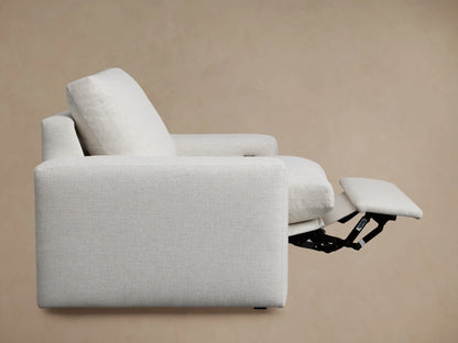 White Kipton Wide Arm Motion Recliner, viewed from the back-right. Features wide arms, high back cushion, textured fabric.