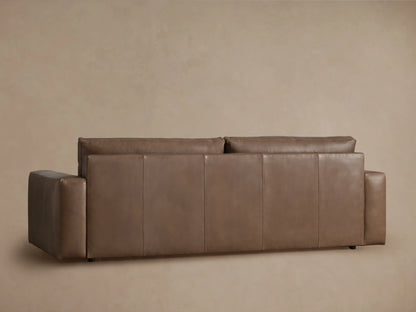 Back view of Kipton Wide Arm Leather Sofa in warm brown. Features clean lines, wide arms, and stitched back panels.
