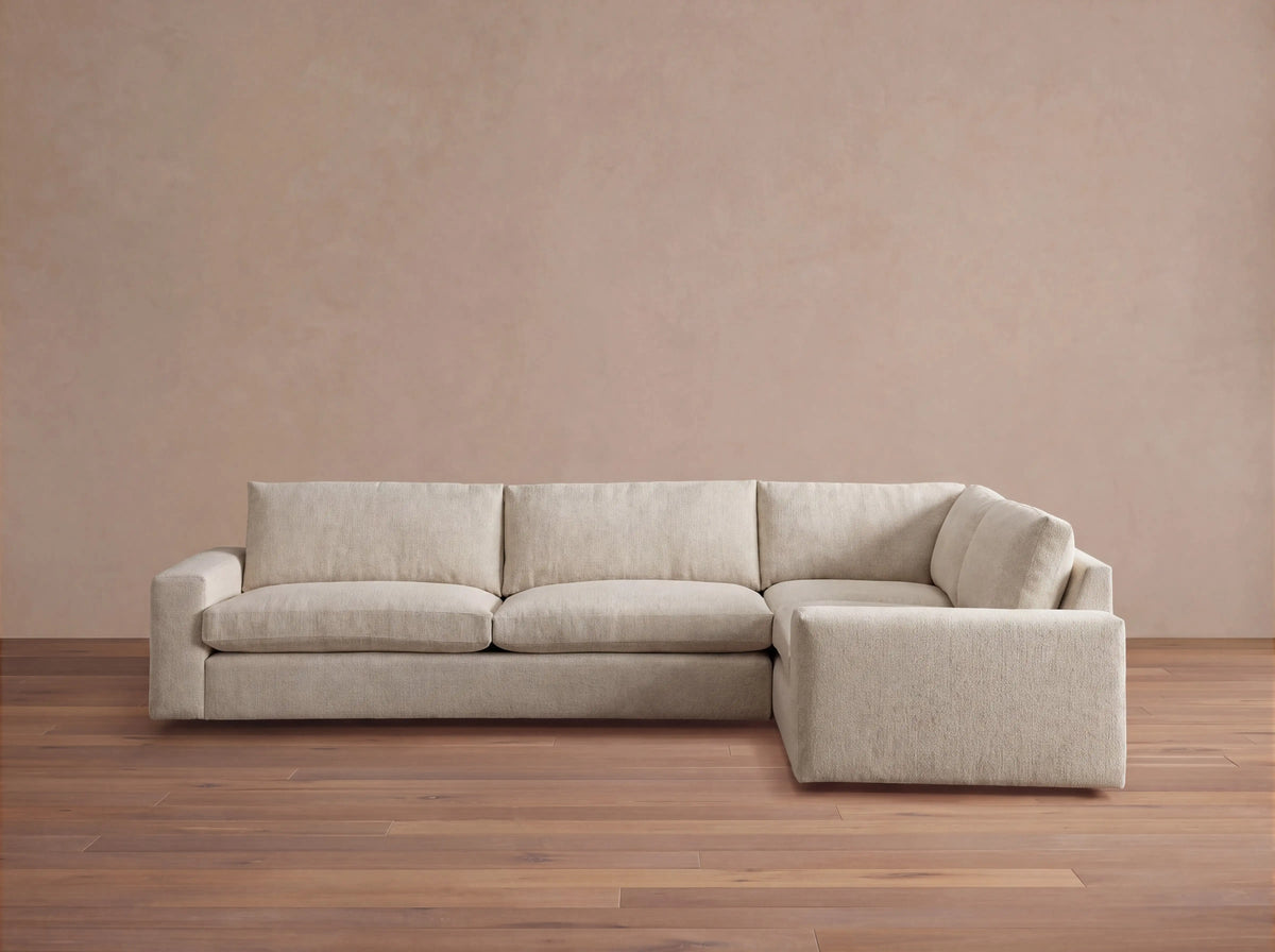 Kipton Wide Arm Two-Piece Sectional, L-shaped, in light beige fabric, with plush cushions, viewed from the front.