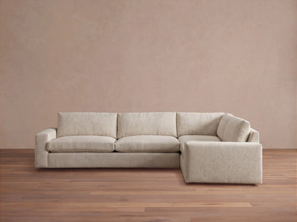 Kipton Wide Arm Two-Piece Sectional, L-shaped, in light beige fabric, with plush cushions, viewed from the front.