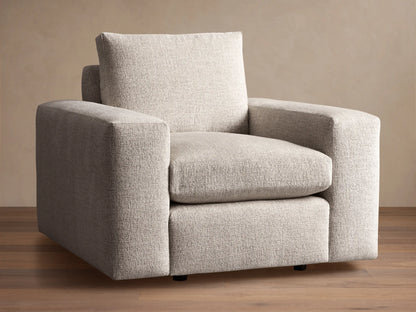 Kipton Wide Arm Swivel Chair. Modern, light beige textured fabric with wide square arms and plush cushions, angled right.