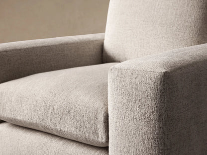 Light beige Kipton Wide Arm Swivel Chair with textured fabric, wide squared arms, and plump cushions, front view on wood floor.