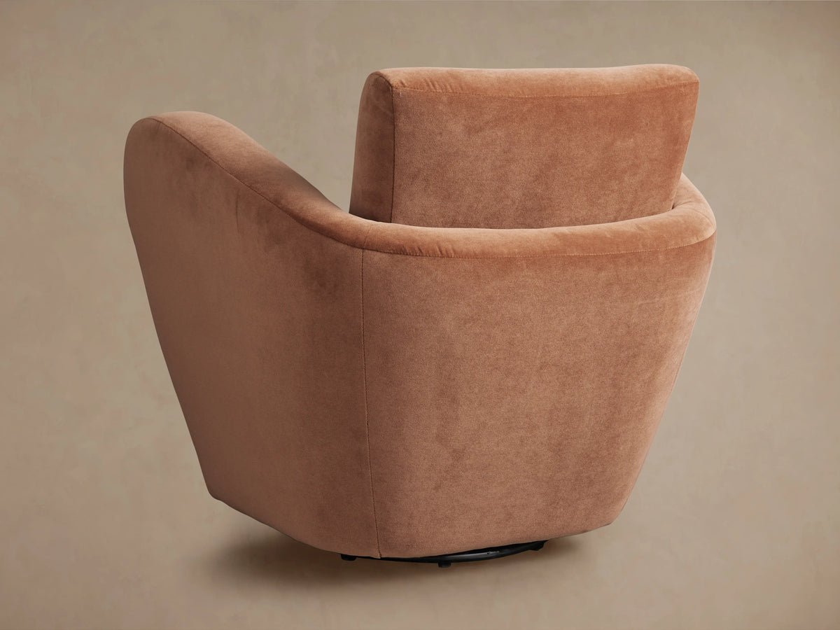 Close-up, angled view of Amelia Swivel Chair's plush mocha velvet back and armrest, showing soft curves.