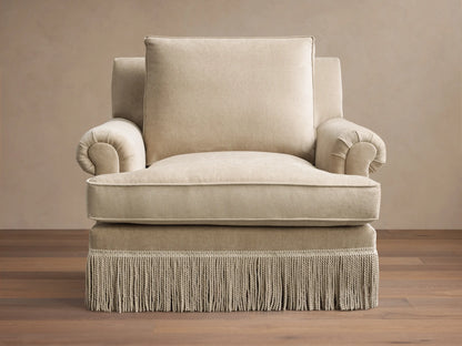 Front view of the beige McKinley Chair with Fringe, featuring rolled arms and a decorative fringe base.